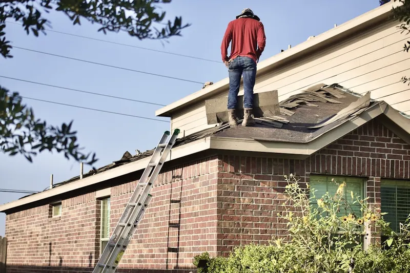 Professional roofer working on a residential roof in Village at Aviano